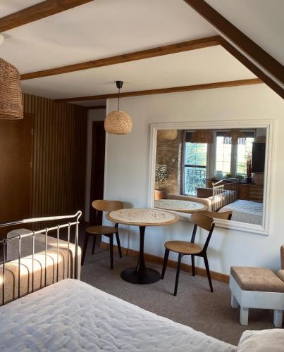 a bedroom with a bed and a table and chairs at Noclegi pod Słonecznikiem in Gąsawa
