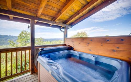 a hot tub on the deck of a tree house at Journey's End in Gatlinburg