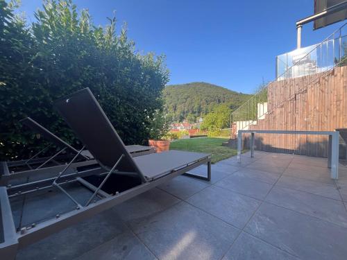 a bench sitting on top of a patio at Bonne âme - Ferienwohnung mit Sauna in Sankt Martin