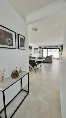 a living room with a couch and a table at Modern & Chilled Stay in Bayswater in Perth