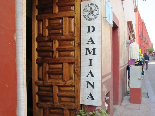 a sign on the side of a building at Hotel Damiana Boutique in Querétaro