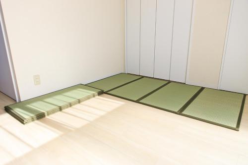 an empty room with green and white walls and floors at NT Building in Nagoya