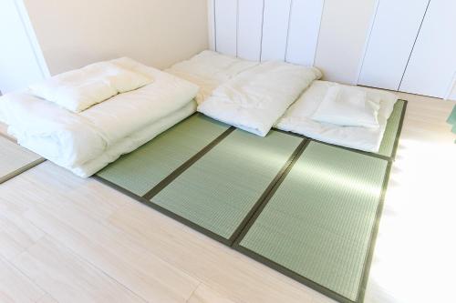 a room with a bed and a glass floor at NT Building in Nagoya
