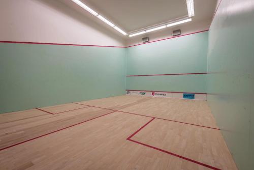 an empty gymnasium with a wooden floor in a room at Hotel TENIS in Zvolen