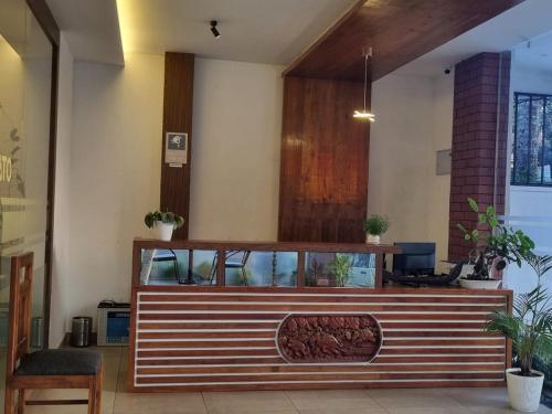 a restaurant with a counter with plants on it at Hotel trees thekkady in Thekkady