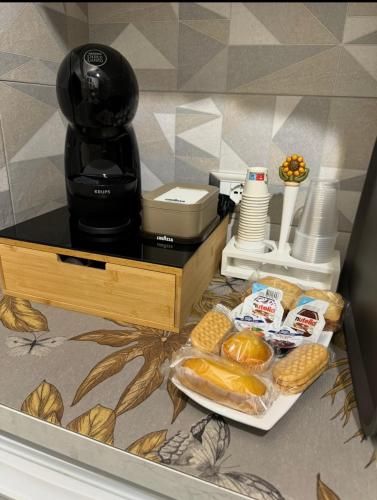 a counter with a coffee maker and a tray of bread at Semplice Dimora Ostuni in Ostuni