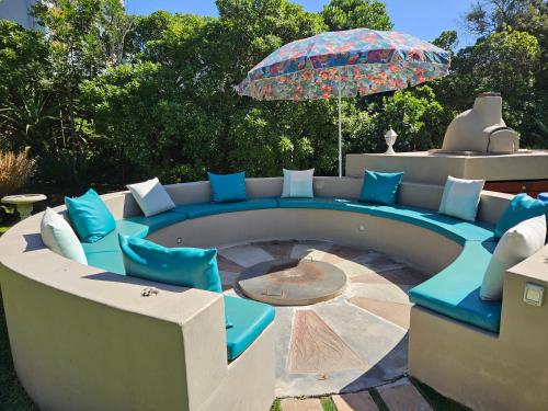 a patio with blue chairs and an umbrella at The Gull in Sedgefield