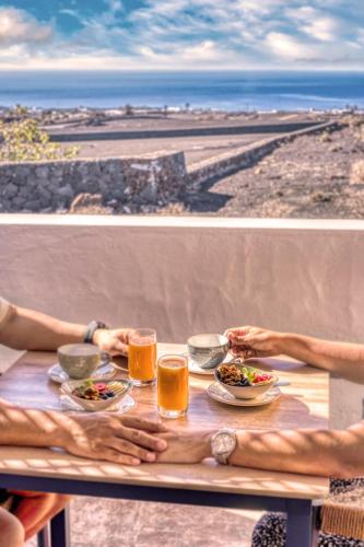 two pictures of people eating at a table with drinks at Casa Serena 10 Boutique- Adults Only-Breakfast Included in Mácher