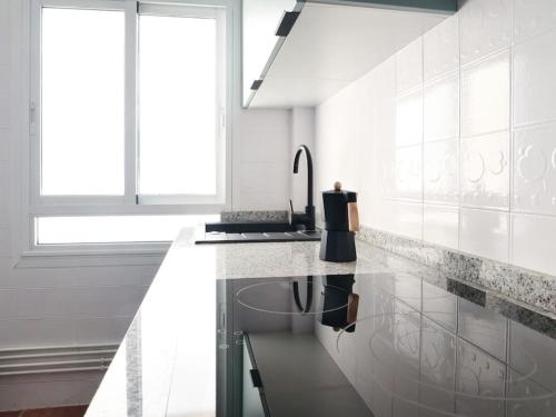 フェロルにあるApartamento Porta Novaの白いキッチン(シンク、カウンター付)