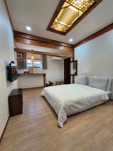 a bedroom with a large bed in a room at Yeonyijae hanok stay in Gyeongju