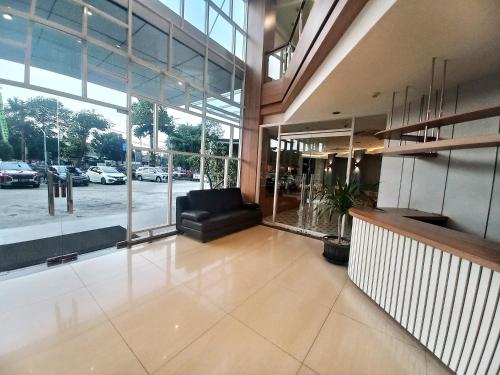 a lobby with a black leather chair in a building at Hotel 88 Kedoya Jakarta in Jakarta