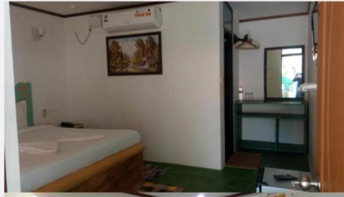 a small room with a bed and a mirror at Rock Bite Beach Resort morjim beach in Old Goa