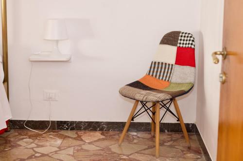 a chair with a sweater on a wall at BED&BREAD Piazza 'Nzegna in Carovigno