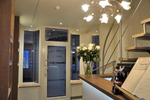 a kitchen with a vase of flowers on a counter at Hotel Brasserie De Beiaard in Torhout