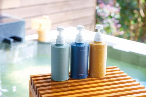 two bottles ofodorizers are sitting on a table at Hotel Grand Bach Atami Crescendo in Atami