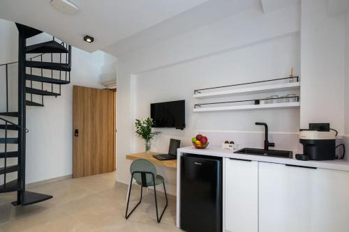 a kitchen with a counter and a table in a room at KEDL Junior Suites in Kalamata
