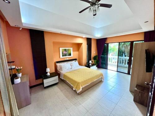 a bedroom with a bed and a ceiling fan at Smokers Resort in Pattaya South