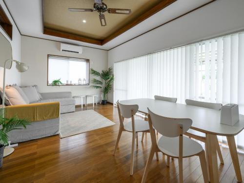 a living room with a white table and chairs at SEA EIRENE Hillstop Onnason in Inbu