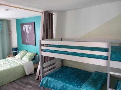 two bunk beds in a small room with a bed at Mont saint michel normandie in Sainte-Cécile