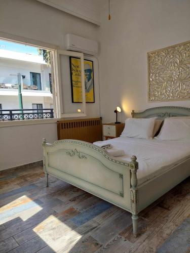 a bedroom with a large bed in a room with a window at City Center First Floor Apartment in Kos