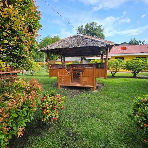 a gazebo with a table and chairs in a yard at Casa Celine Dumaguete in Dumaguete