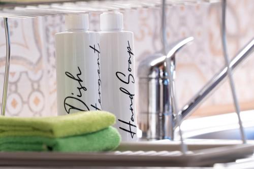 a close up of two bottles of detergent next to a sink at Suflora in Mengara