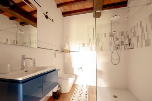 a bathroom with a sink and a toilet and a shower at Suflora in Mengara
