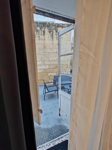 an open door to a room with a bench outside at Cosyroom 3 in Pieta