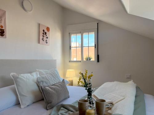 a bedroom with a white bed with a window at TiétarHomes 4A in Navalmoral de la Mata
