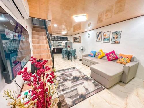a living room with a couch and a table at Maddox Homestay Fully airconditioned in Mandaue City