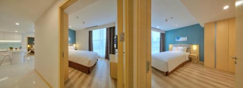 Ένα ή περισσότερα κρεβάτια σε δωμάτιο στο Holiday Inn Express Luoyang Yichuan by IHG
