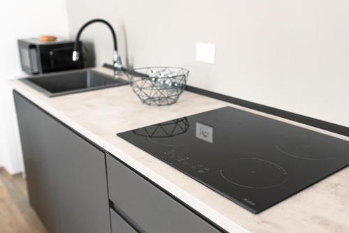 a kitchen counter with a sink and a stove at Borgo Cavour Luxury Apartments - Centro storico in Fano