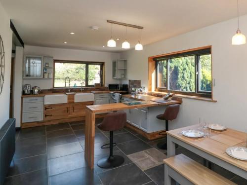 a kitchen with a table and some chairs in it at Meadowside in Weaverthorpe