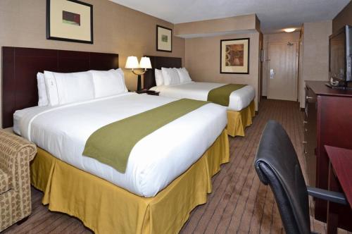 a hotel room with two beds and a desk at Holiday Inn Express Boston Brockton by IHG in Brockton