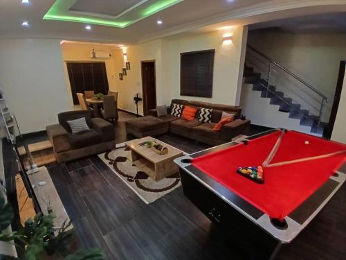 a living room with a red pool table in it at DELIGHTFUL ! 3 BEDROOM TERRACE DUPLEX EN-SUITE ORCHID RD LEKKI AIRCON WiFi in Lagos