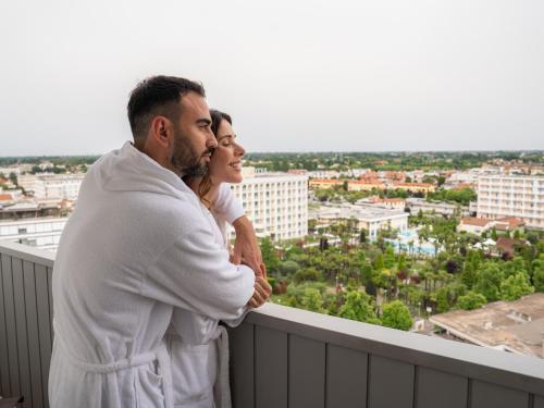 a man and woman standing on top of a building at Plaza Hotel Abano Terme in Abano Terme