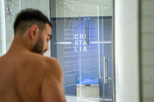 a man walking in front of a glass door at Plaza Hotel Abano Terme in Abano Terme