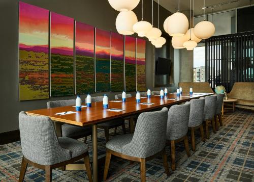 a conference room with a long table and chairs at Hyatt Place Pena Station/Denver Airport in Denver