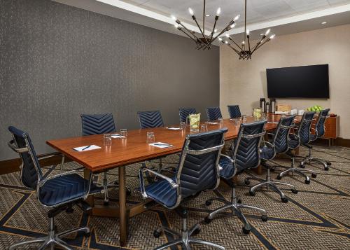 a conference room with a long table and chairs at Hyatt Place Pena Station/Denver Airport in Denver