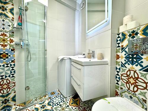 a bathroom with a toilet and a sink and a shower at Park View Studio in Timişoara