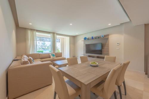 a living room with a table and a couch at Elegant apartment with pool and beach access in Hurghada