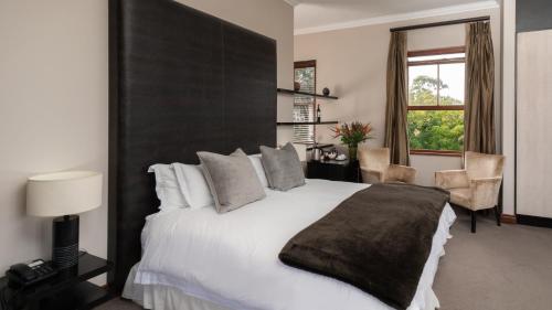 Postel nebo postele na pokoji v ubytování Nova Constantia Boutique Residence