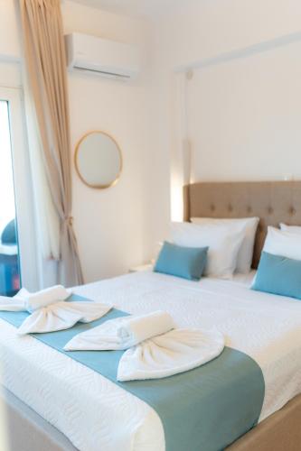 a bedroom with two beds with towels on them at VDG Seafront Elegant Residence in Rethymno Town