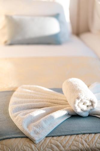 a towel sitting on top of a bed at VDG Seafront Elegant Residence in Rethymno Town