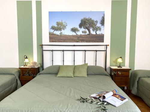 a bedroom with a bed with a book on it at Azienda Agrituristica Bergi in Castelbuono