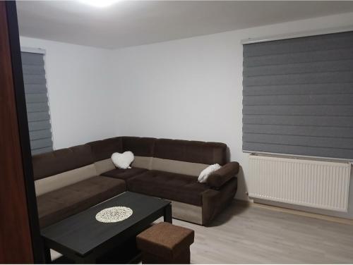 a living room with a brown couch and a table at Stan na dan Zvornik in Zvornik