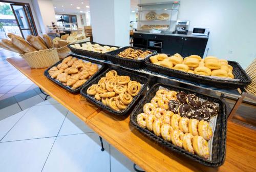 a table with trays of different types of donuts at Ona Palm Beach in Playa de las Americas
