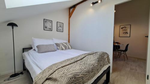 a bedroom with a bed and a table with a chair at Apartament Quiet Street 11, 6E in Oświęcim