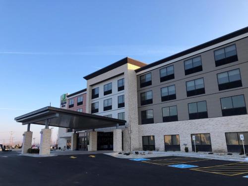 a large building with awning in a parking lot at Holiday Inn Express & Suites Racine by IHG in Racine