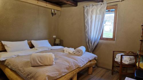 a bedroom with a bed with two towels on it at Holiday House Clavis in Dobrovnik